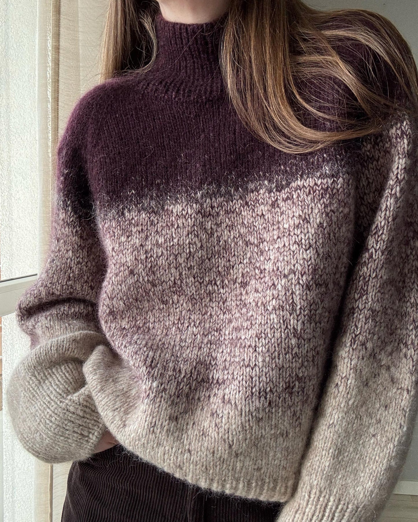 Calista sweater knitwear pattern with high neck and raglan design.