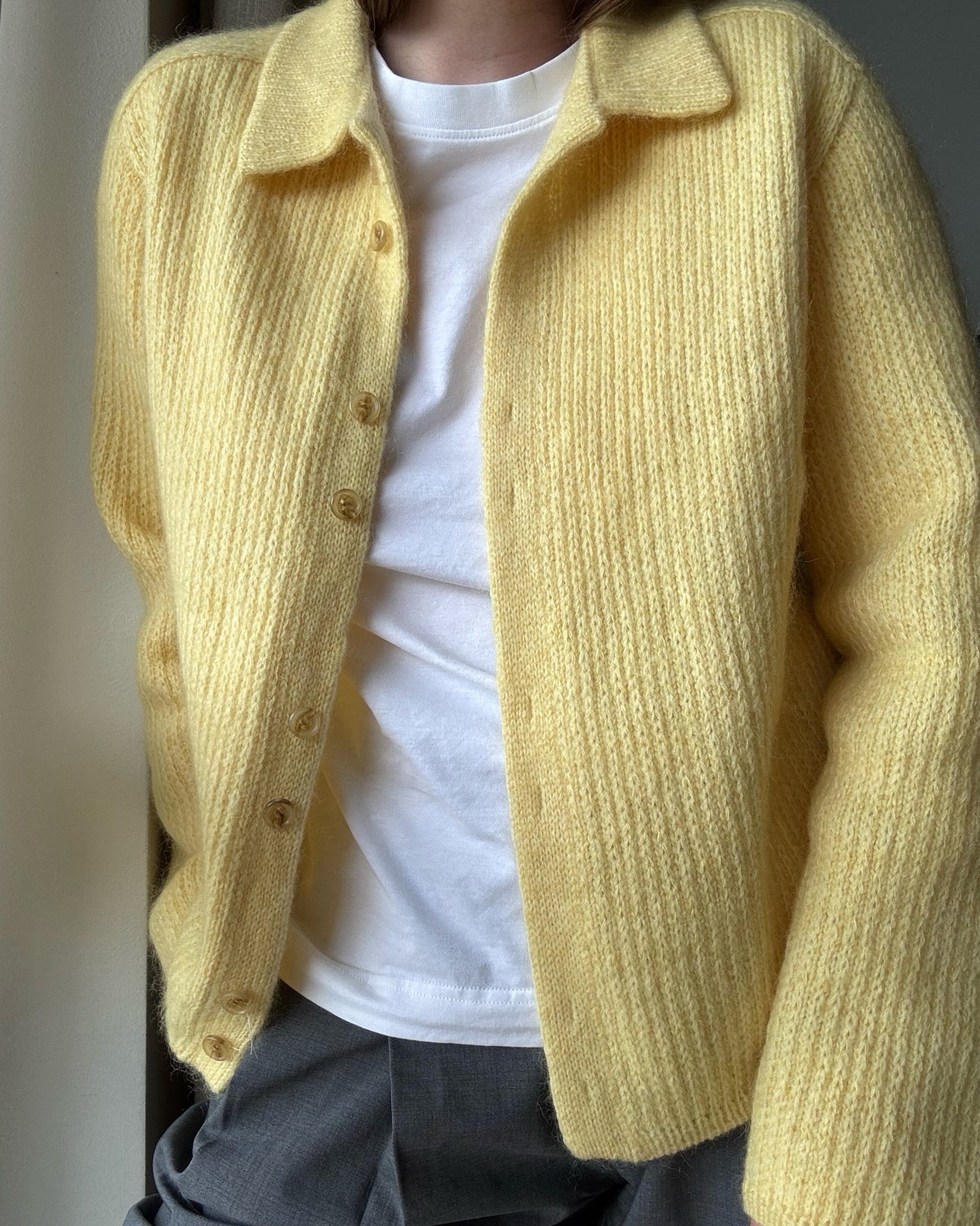 Overhead flatlay of Chantal Collar Cardigan highlighting double knitting edges and precise saddle shoulder shaping.