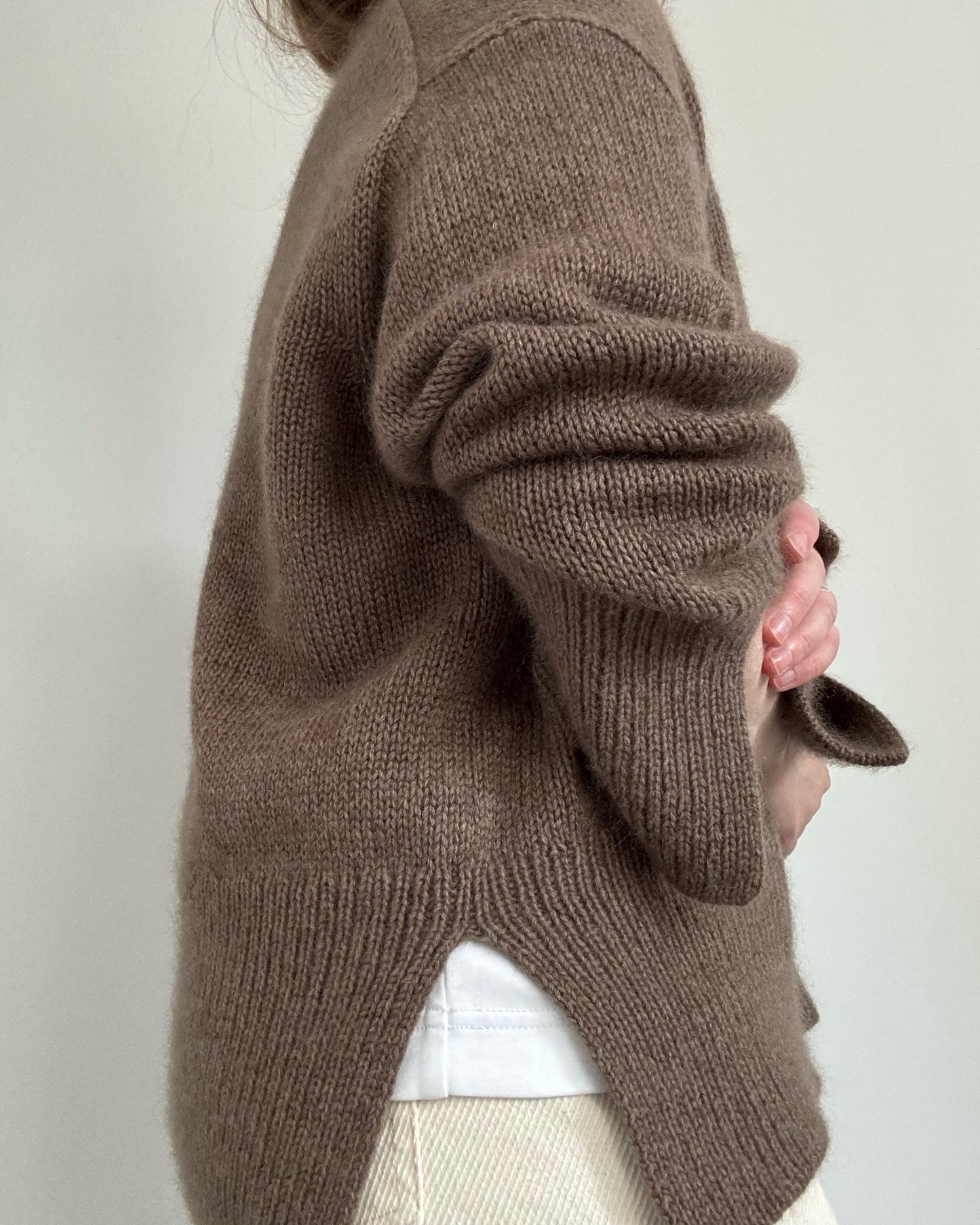 Overhead flatlay with Knit Blueprint and Knitting Instructions beside finished Ciro Sweater crewneck.