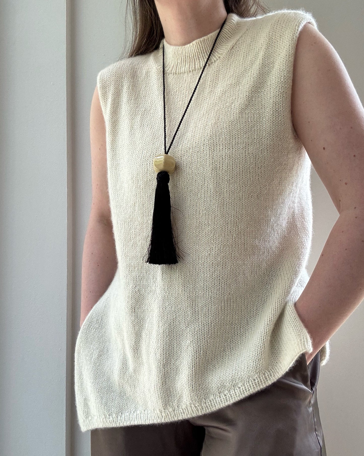 Close view highlighting sparse knit texture and refined mock neck edge of Liv Top intermediate pattern.