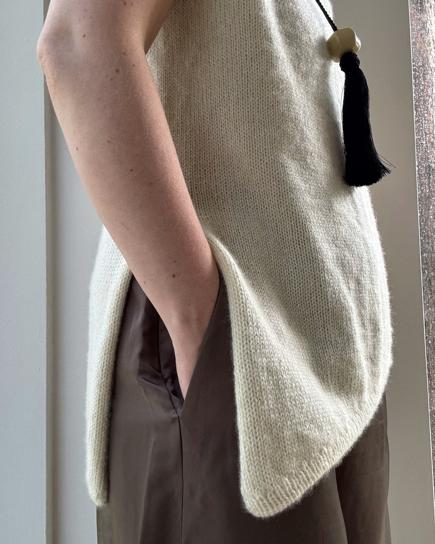 Back angle reveals smooth stockinette fabric and classic silhouette created by 23 by 32 gauge in cashmere wool.