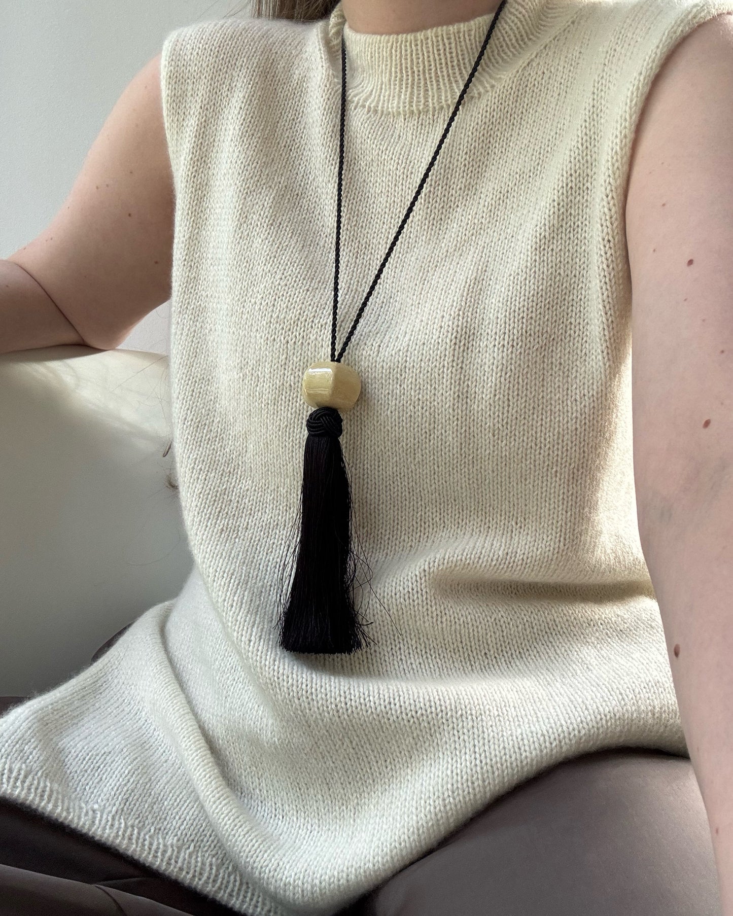 Progress shot documents top down knitting on circular needles forming regular fit asymmetrical shoulder.