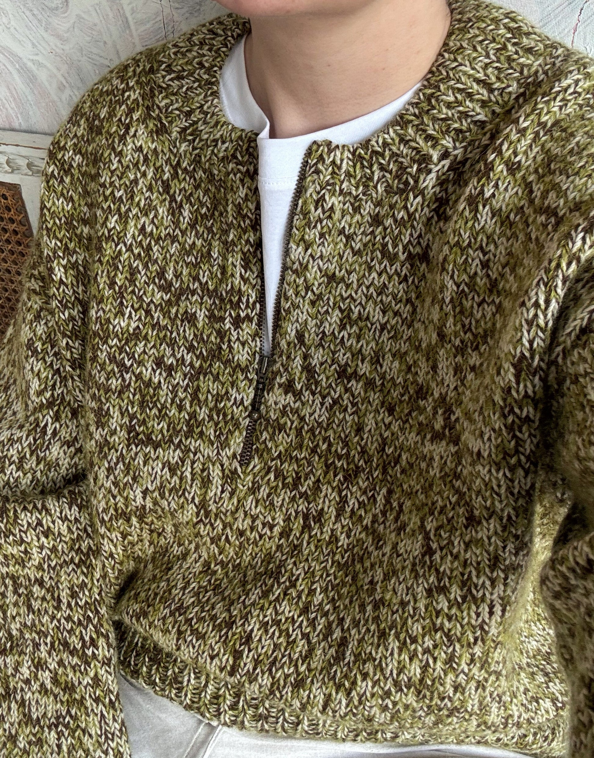 Close look at the zip neck placket and o neck shaping on the knitted pullover