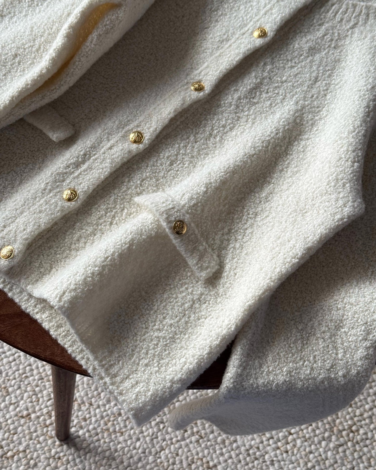 Elegant Manon Jacket with rounded neck and button-up closure.