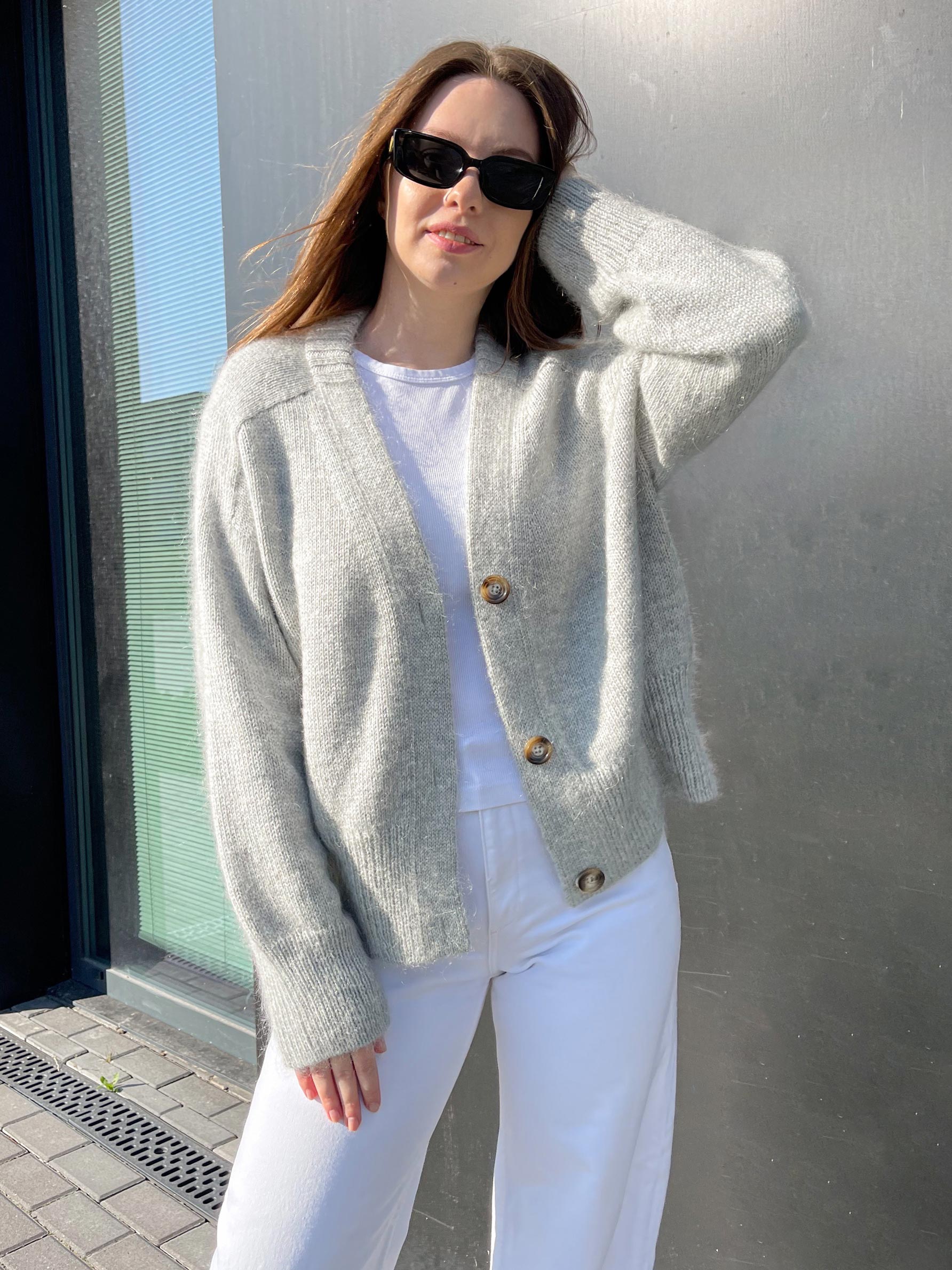 Paul Cardigan in gray color, showcasing its deep V-neck and button-up design, knitted with wool and mohair blend yarn