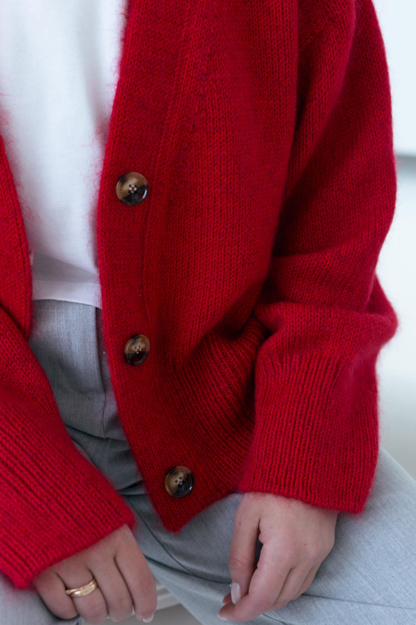 Crafting process of the Paul Cardigan, showing a portion of the garment being knitted in DK 11wpi yarn.