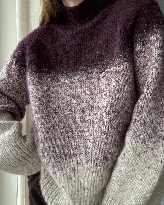 Strikkevejledning til rullekrave sweater med farveblanding.