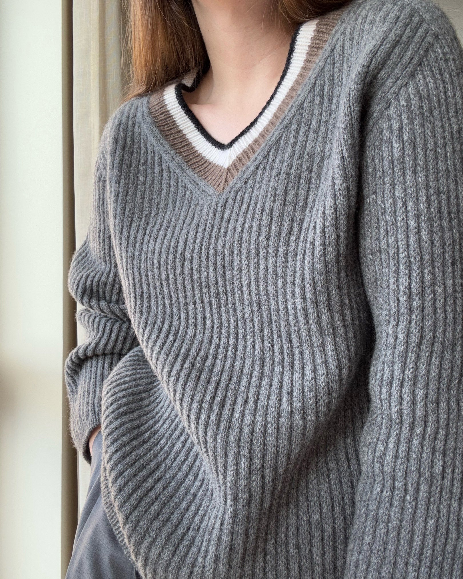 Modern jumper with refined design and aesthetic slip stitch detailing.