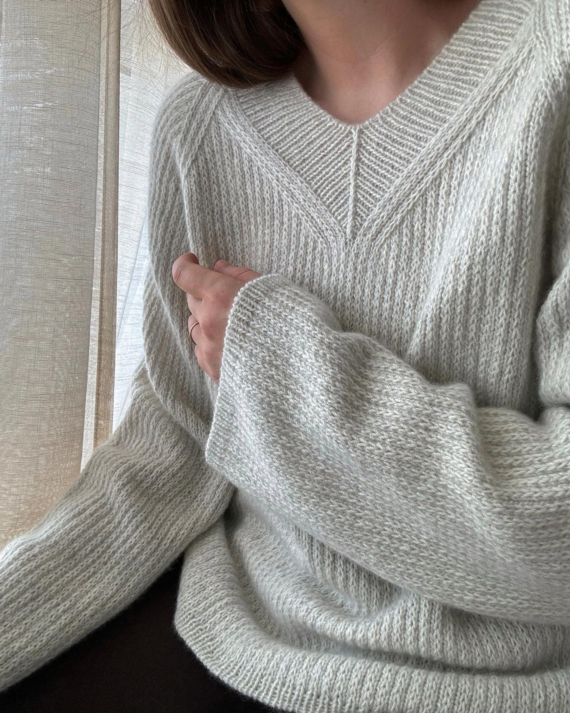 Feminine Chantal Sweater V-neck knitting pattern by Moreca Knit, featuring top-down construction and slip stitch design.