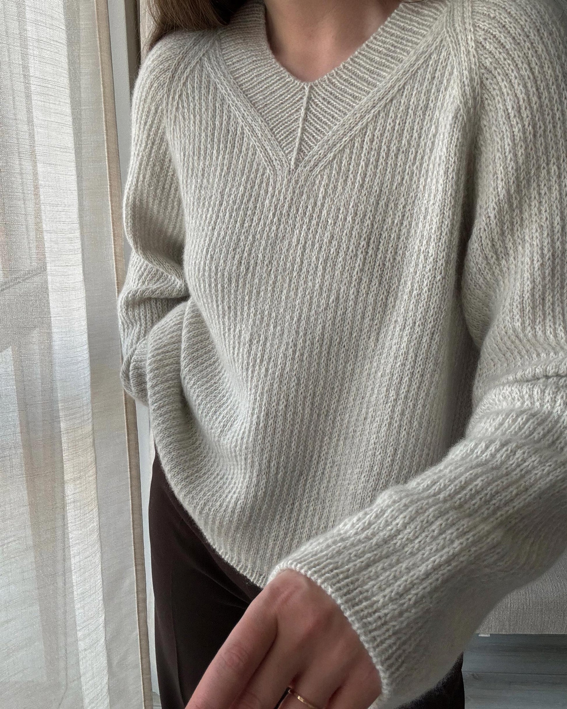 Detailed knitting guide for Chantal Sweater V-neck with modern design elements and top-down construction.