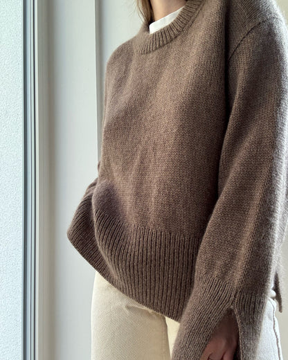 Front pose highlights rounded o neck and double knitting rib neckline with minimalist aesthetic.