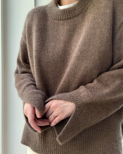 Relaxed stance displays oversized fit and side slits of the classic stockinette jumper from the Knit Guide.