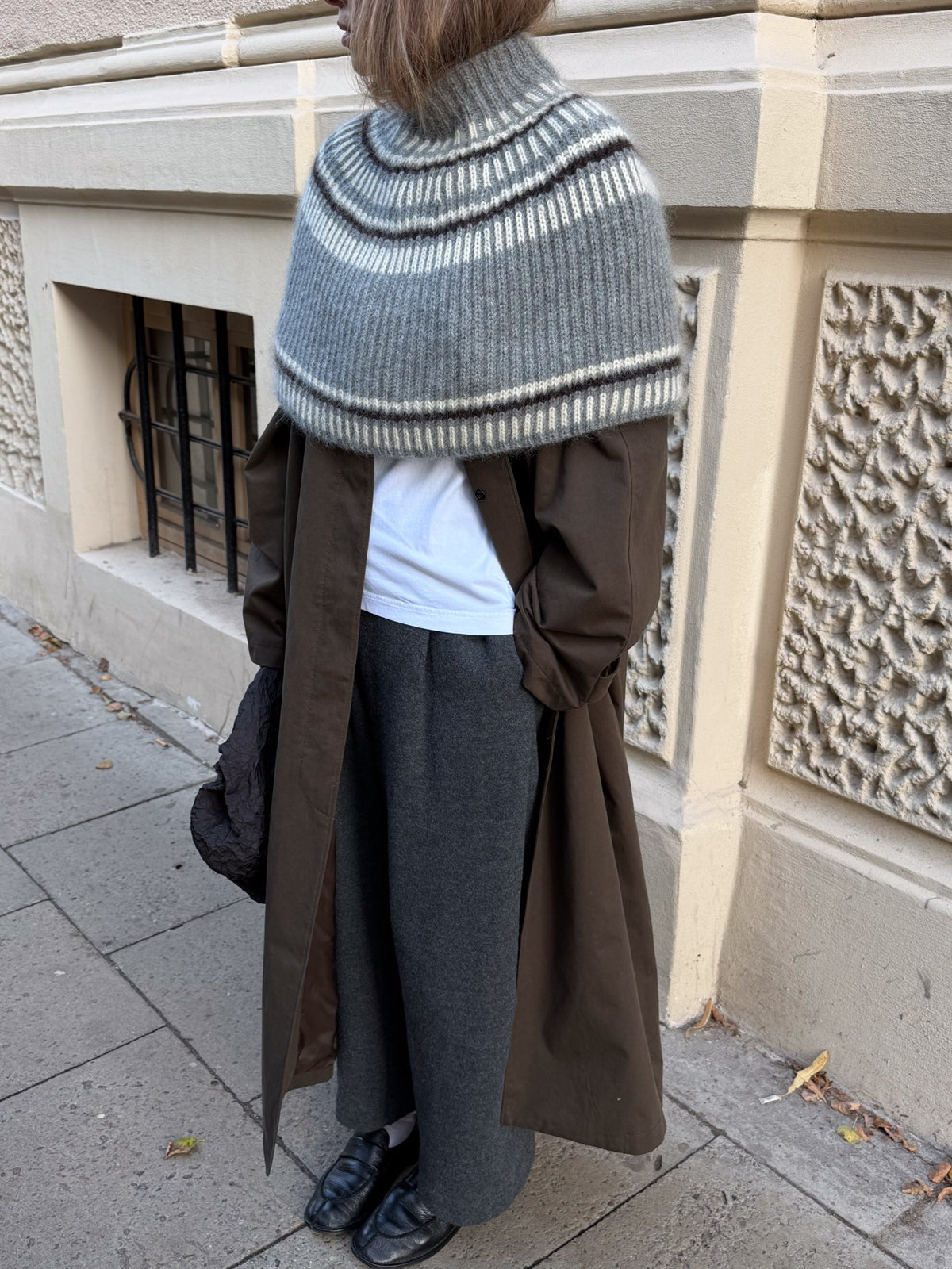 Cropped upper body view focused on the high turtleneck and pronounced ribbed texture.