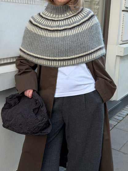 Three quarter back view showing the neck height and continuous textured fabric across the shoulders.