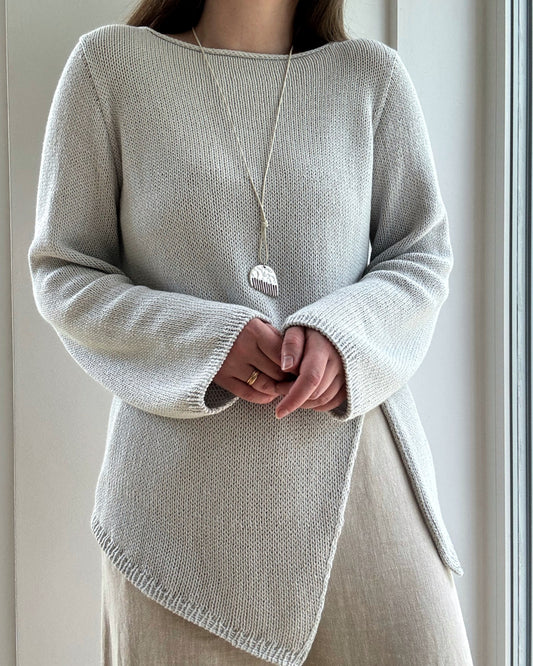 Liv Blouse displayed flat shows modern boatneck and asymmetrical top down construction in regular fit cotton linen silk fabric.
