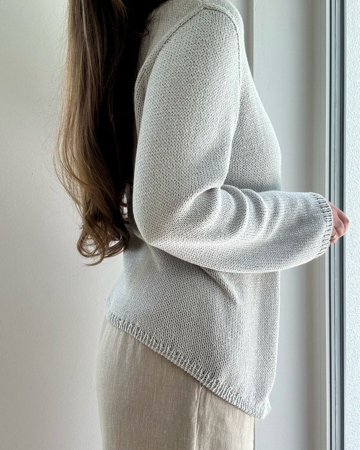Lifestyle scene shows contemporary minimalistic Liv Blouse styled for womens spring knitwear wardrobe.