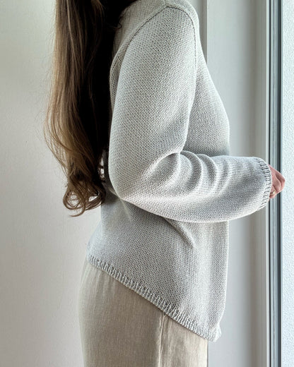Lifestyle scene shows contemporary minimalistic Liv Blouse styled for womens spring knitwear wardrobe.