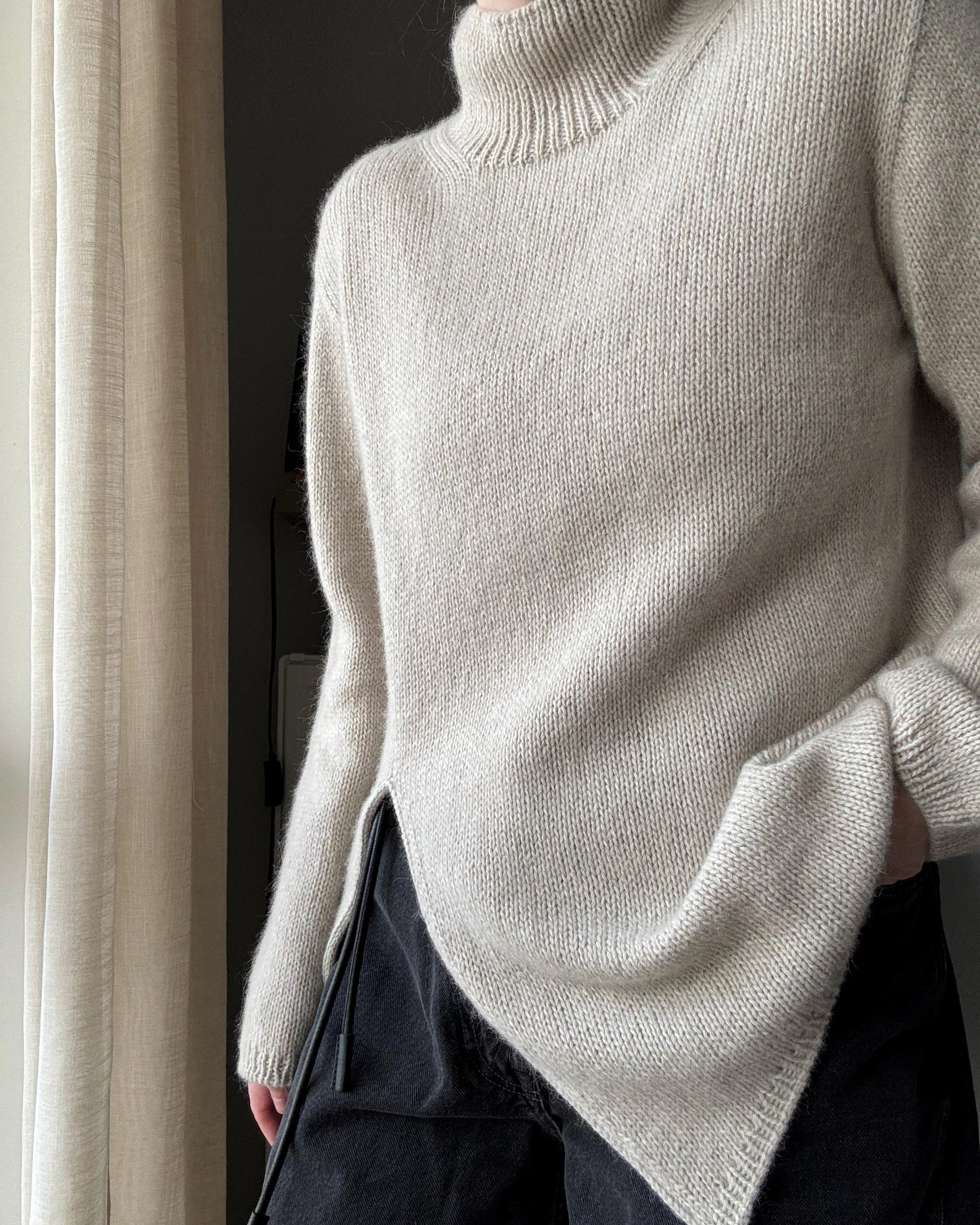 Top-down mock neck sweater created with refined stockinette stitch for a minimalistic aesthetic.