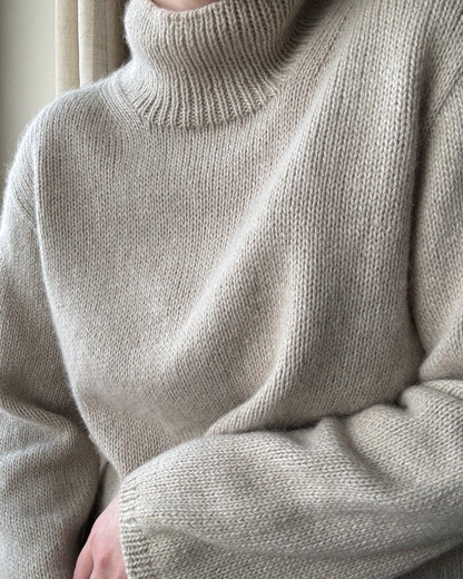 Intermediate-level knit pullover highlighting a regular fit and sparse knit details.