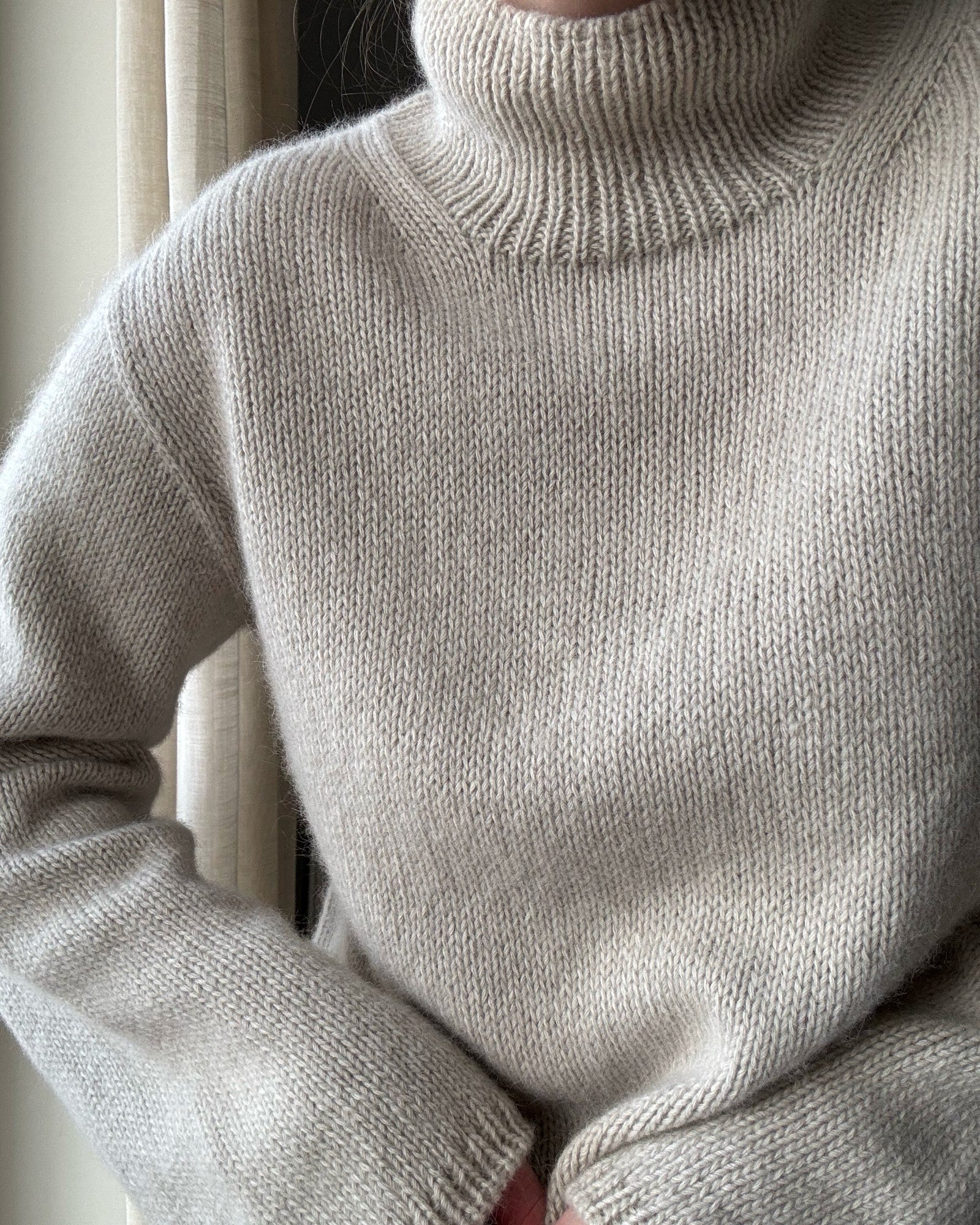 Detailed look at the regular fit shaping in a feminine aesthetic sweater pattern.