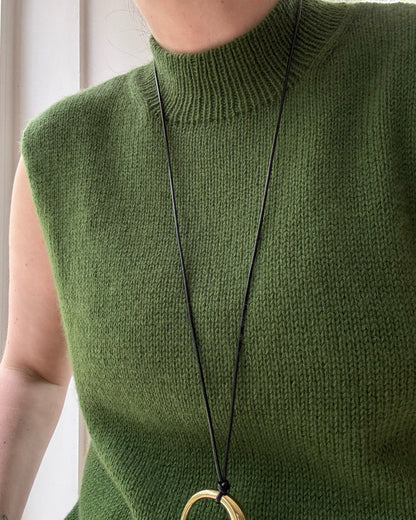 Detaljebillede fokuserer på overgang fra mock neck til rund hals og skaber æstetisk minimalistisk stil.