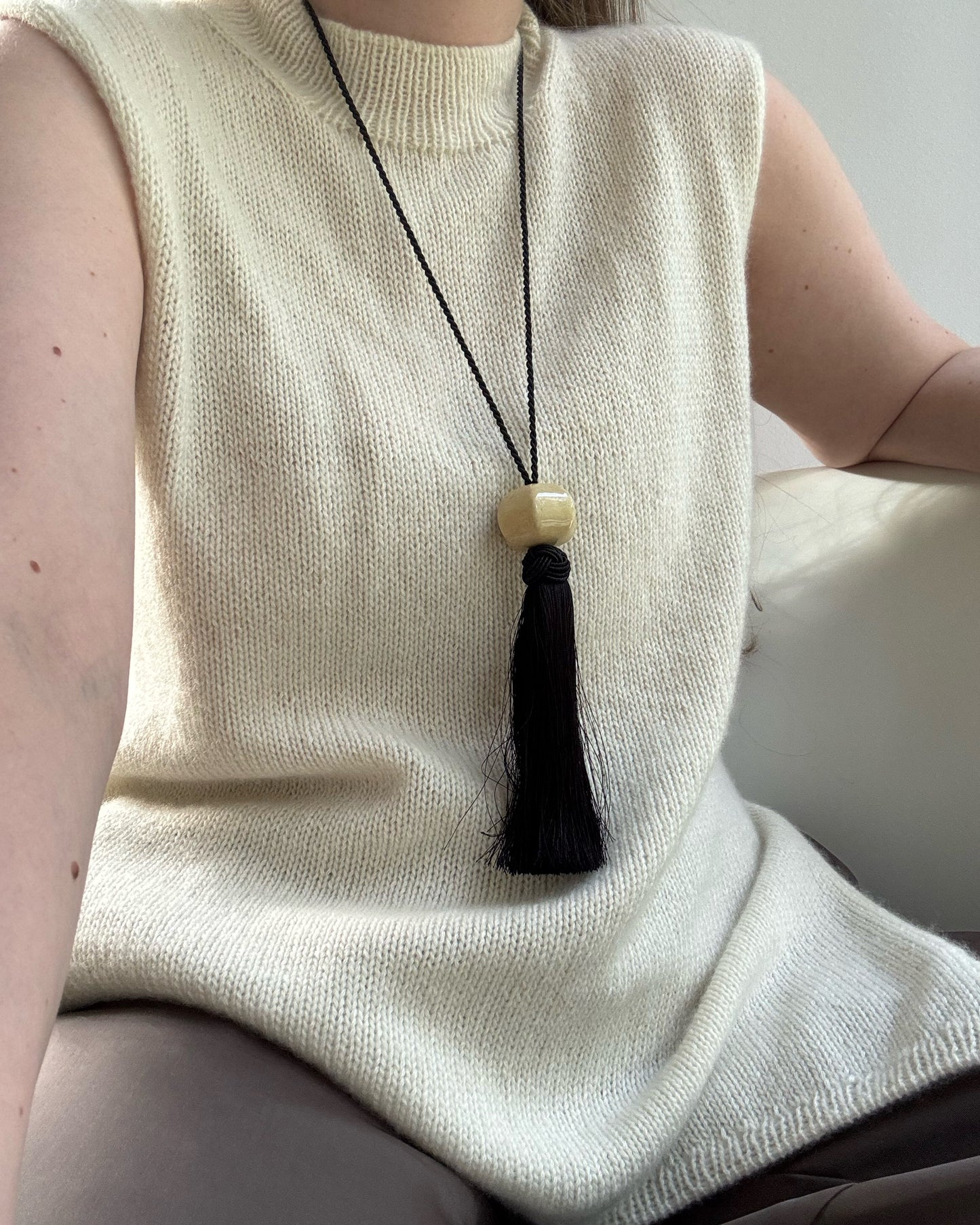 Detaljbilde fokuserer på overgangen mellom mock neck og rund hals og gir minimalistisk stil.