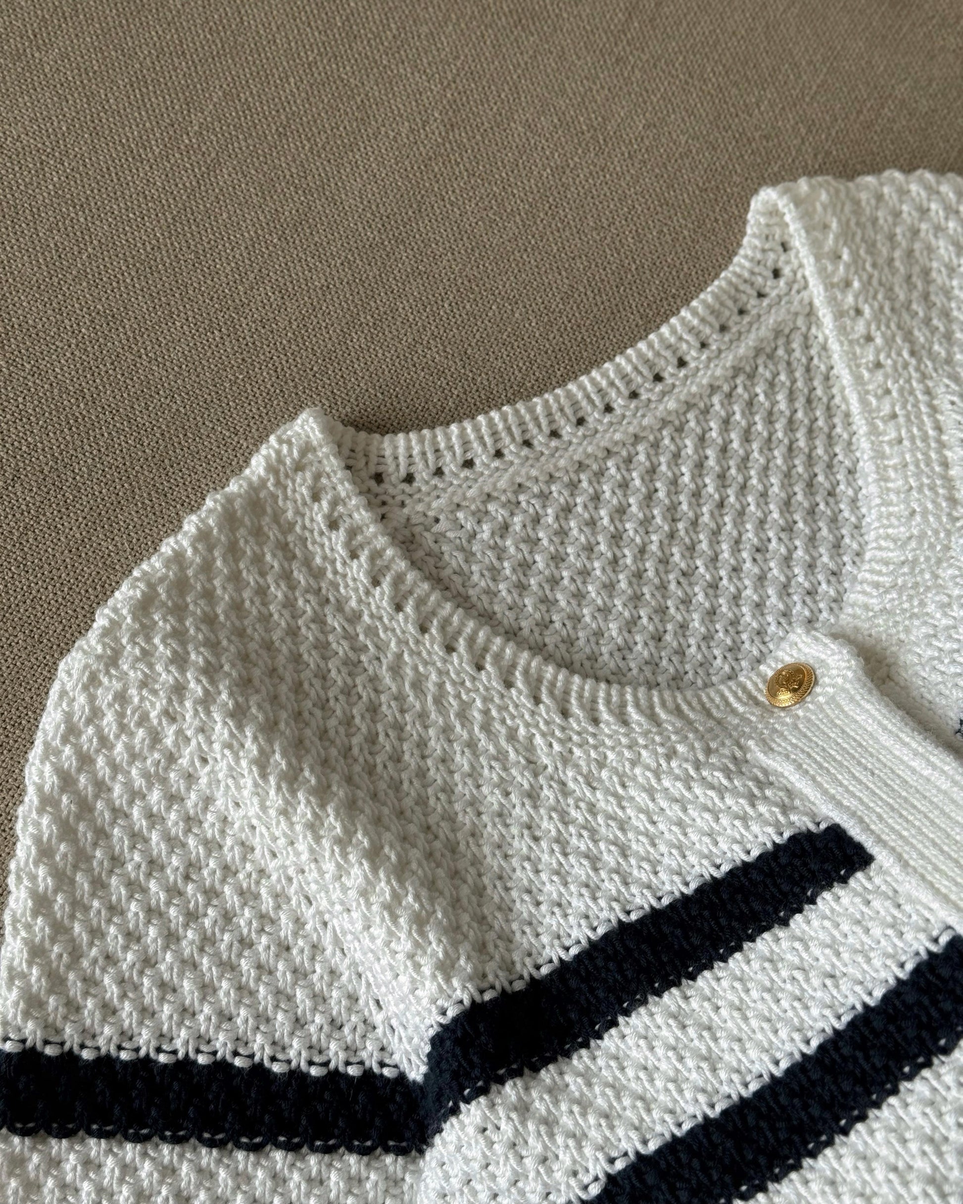 Manon Cardigan knitting pattern with crewneck and button-up in white.