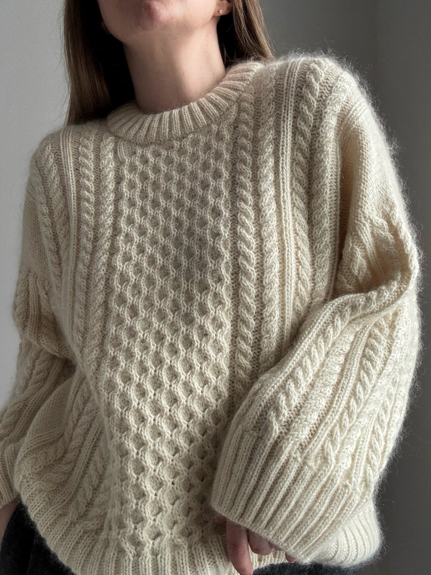 Oversize Ninon Sweater mit Zopfmuster und Rundhalsausschnitt am Modell von Moreca Knit