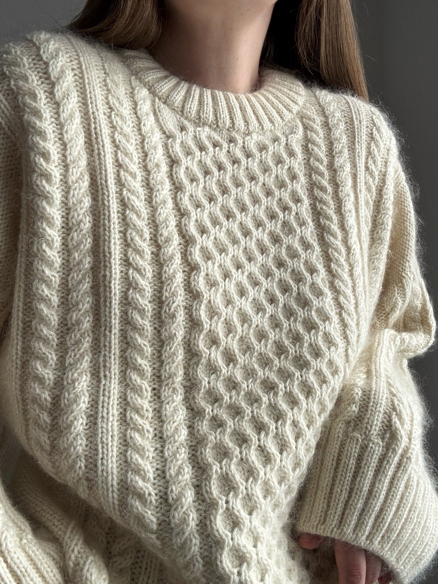 Wspolczesny sweter warkoczowy z okraglym dekoltem i detalami dzianiny podwojnej