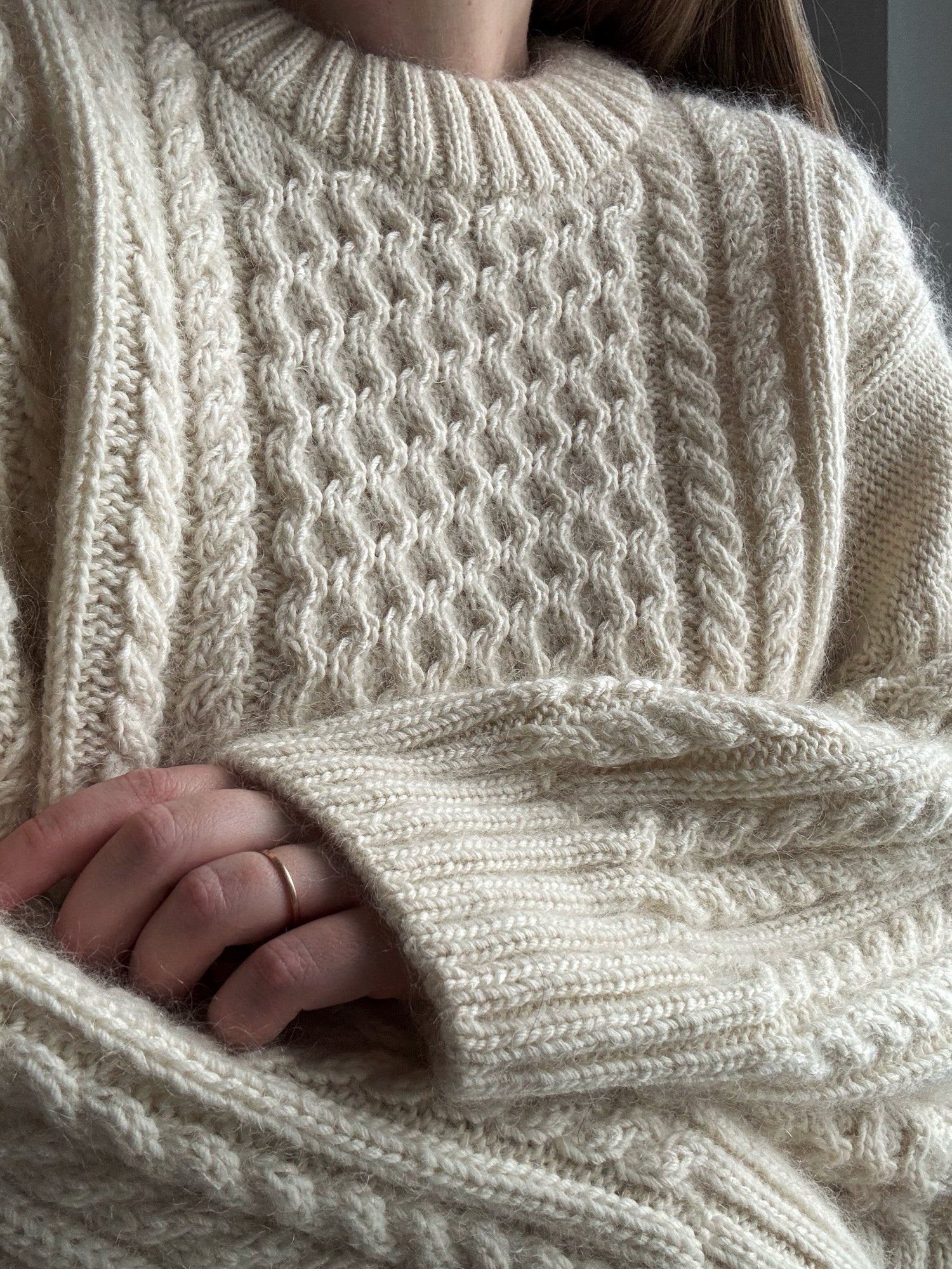 Womens oversized sweater knitting pattern with structured cables and relaxed fit