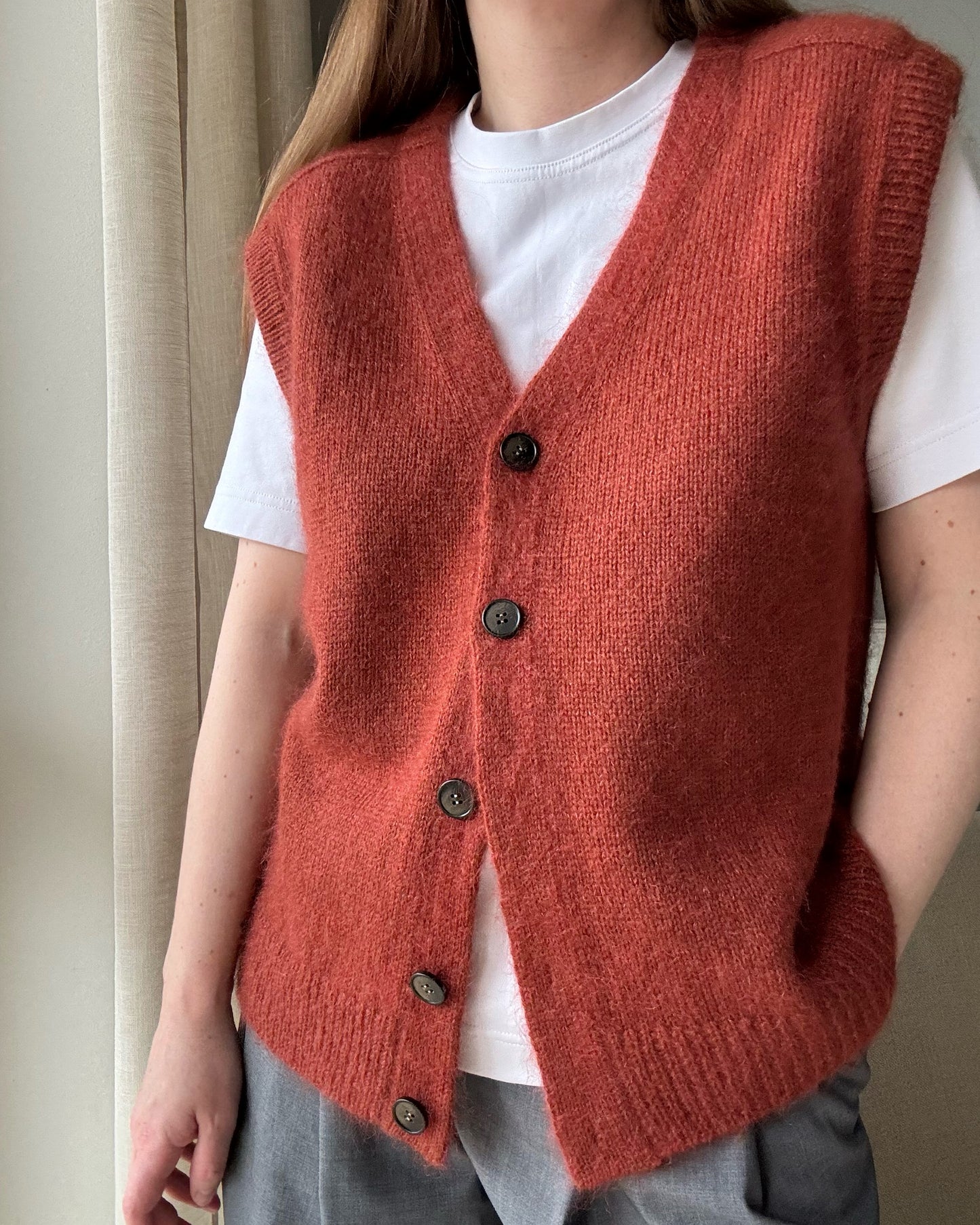 Regular fit vest pattern showcasing top down knitting with stockinette stitch and classic button up detail.