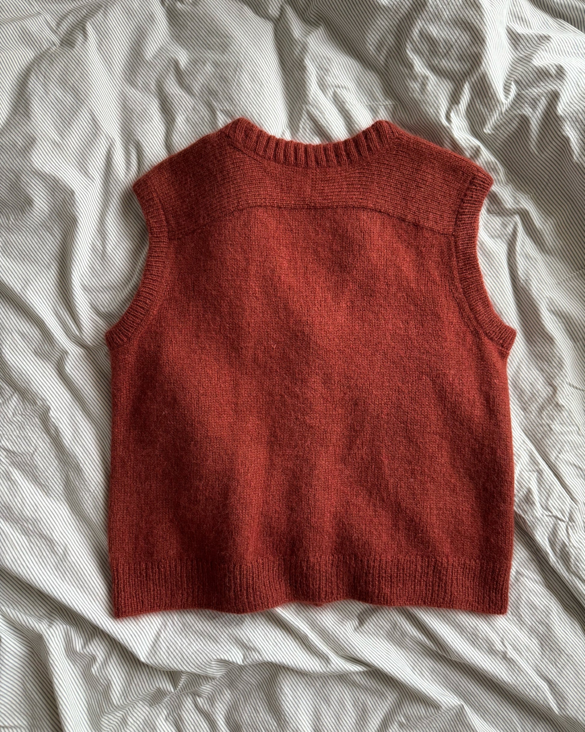 Classic advanced knitting instructions for a soft vest with stockinette stitch and top down technique.